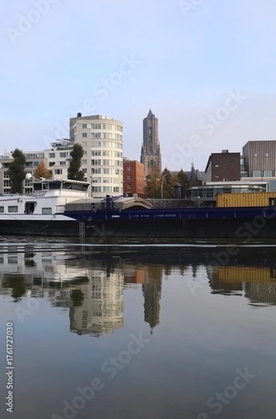 Obraz Skyline of Arnhem in the Netherlands. With the Eusebius church and a cargo ship on the river Rhine. Also a beautiful reflection in the water.