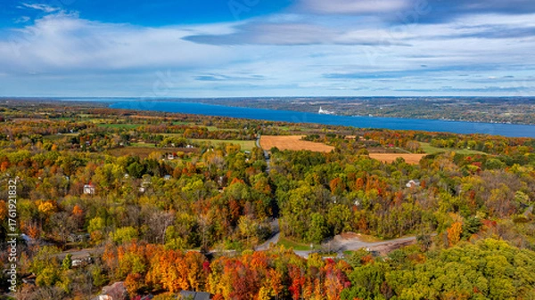 Obraz Trumansburg, NY, USA - October 17, 2025:  Aerial photo over the Village of Trumansburg, NY with view of Cayuga Lake
