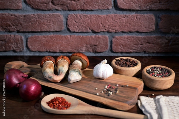 Obraz Red-capped Scaber Stalk mushrooms Leccinum aurantiacum with garlic onion and spices on wooden board