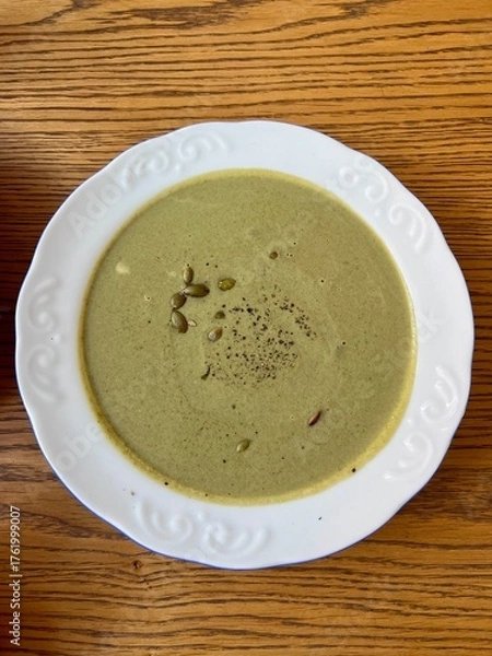 Obraz Pumpkin and broccoli puree cheese soup served on a beautiful, elegant plate