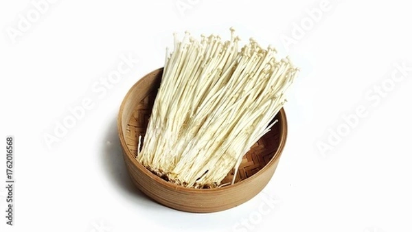 Fototapeta High angle view of Fresh golden needle mushroom or Enoki in bamboo bowl isolated on white background. Enokitake (Flammulina velutipes) from asian cuisine. Delicious for soups and stir-fries cuisine.