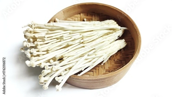 Fototapeta Close up of Fresh golden needle mushroom or Enoki in bamboo bowl isolated on white background. Enokitake (Flammulina velutipes) from asian cuisine. Delicious for soups and stir-fries cuisine.