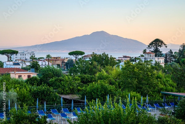 Fototapeta Pre-dawn view from a Sorrento rooftop, with the Bay of Naples and Mount Vesuvius bathed in the soft glow of the approaching sunrise - 2