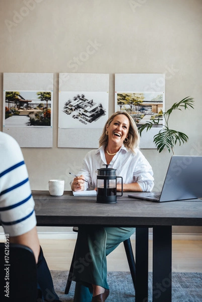 Obraz Professional team discussing architectural projects in a modern office setting