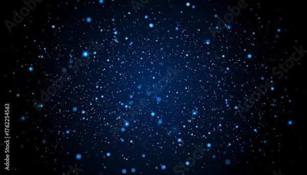 Fototapeta An abstract dark blue background, speckled with glowing particles of various sizes and brightness, creating a cosmic and dynamic effect
