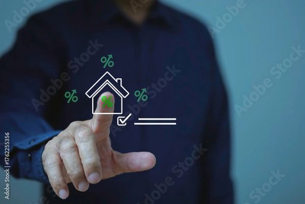 Fototapeta Businessman touching a digital house icon with percentage signs, representing home loan, mortgage rate, property investment, real estate finance for banking and financial planning.
