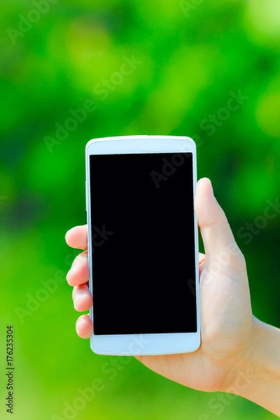 Fototapeta スマートフォンと緑背景