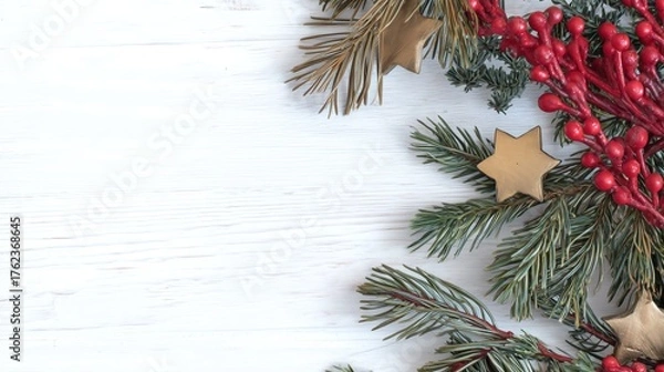 Fototapeta Christmas Composition with Red Berries, Pine Branches and Gold Stars on White Wooden Background for Festive Template