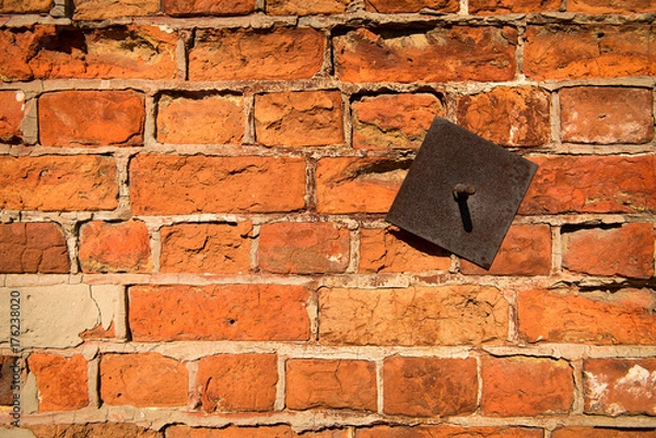 Obraz Wall of old red bricks with an iron insert