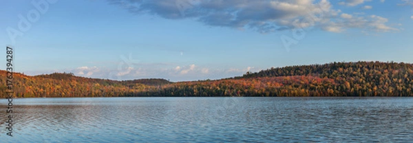 Obraz Panorama of a northern Minnesota lake under hills and trees in fall color at sunset