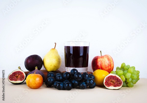 Obraz Grape juice with autumn seasonal fruits.
