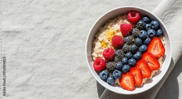 Fototapeta Top-Down Bright Flatlay of Oatmeal Bowl with Berries