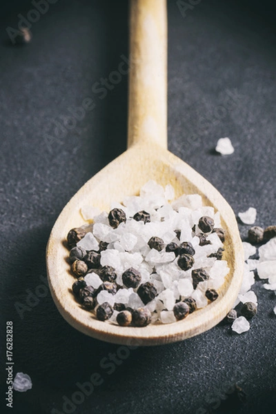 Obraz salt and pepper on a wooden spoon