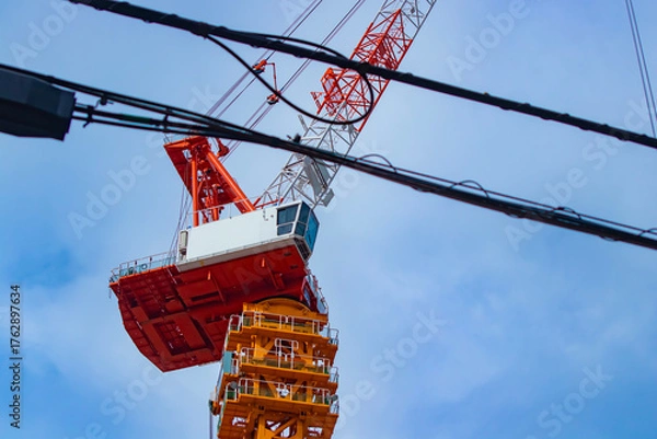 Obraz A cityscape of moving crane and cloud at the under construction telephoto shot