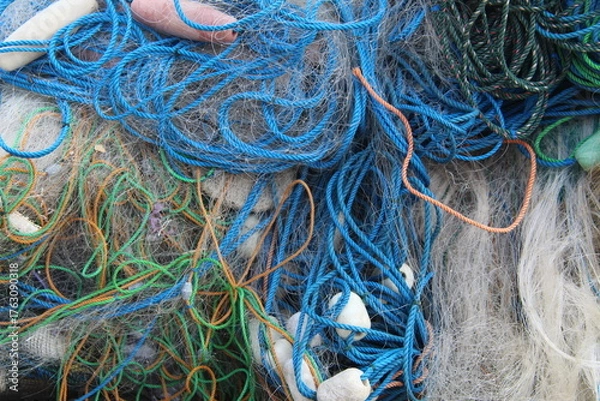 Obraz Colorful tangled fishing nets and ropes in close-up view. Detail texture of marine equipment used by fishermen, symbolizing traditional fishing life and coastal industry.