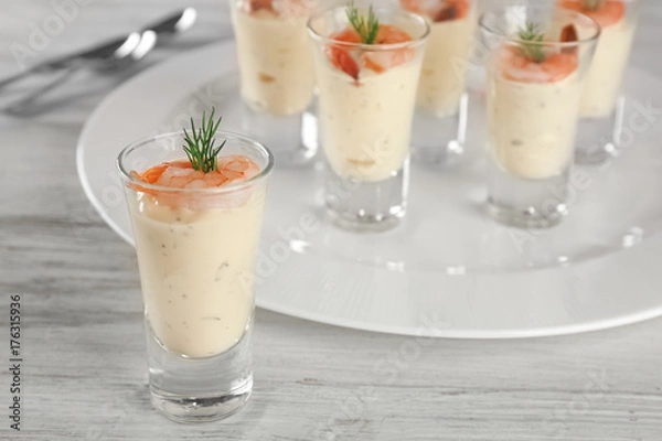 Fototapeta Glass of white sauce with shrimp on table