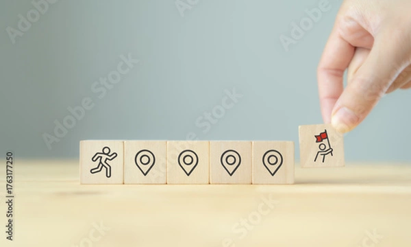 Fototapeta Career Path and Development Strategy Concept. Arranging wooden blocks with icons success roadmap and journey, symbolizing a structured career path and strategic development. Planning, growth, progress