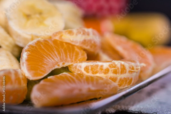 Fototapeta Mandarin slices at the plate.Close-up shoot with shallow depth of field