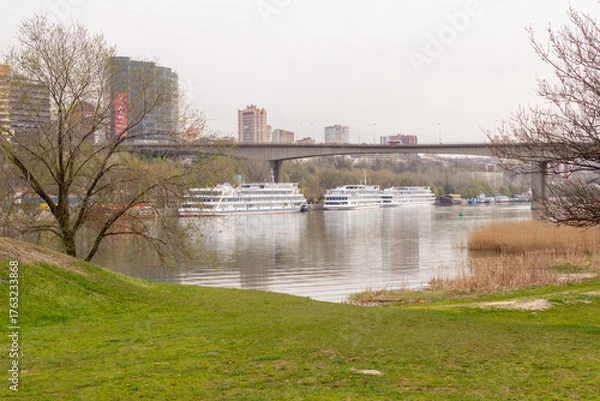 Fototapeta A view of the automobile bridge across the Don River in the metropolis. Urban coastal landscape along the Don River