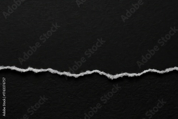 Obraz Torn paper on black background.