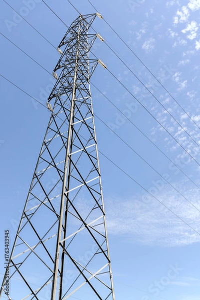Obraz High voltage post. High-voltage tower on blue sky background.