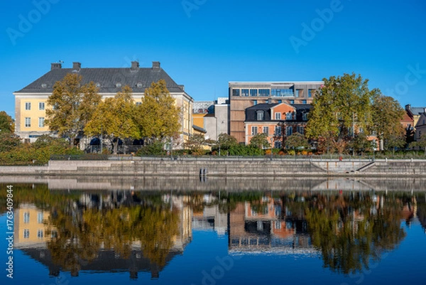 Fototapeta Motala Stream and Norrköping waterfront Saltängen during autumn. Norrköping is a historic industrial town in Sweden.