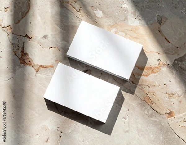 Fototapeta Business card mockup on textured surface with natural shadows, premium printing finish (matte or gloss), top-down photography style