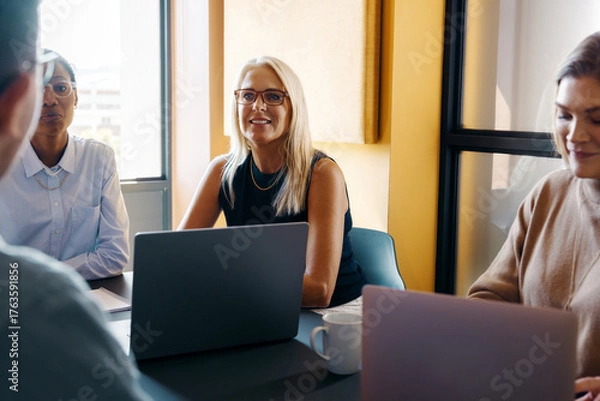Obraz Professional women collaborating in an office setting during a team meeting