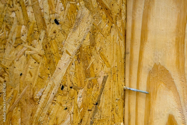 Fototapeta Nail that Missed its Mark as it Passed Through the Particle Board but Missed the Two by Four it was Supposed to Connect With