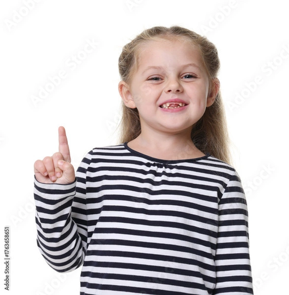 Fototapeta Smiling little girl pointing upwards on white background