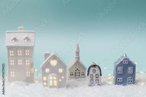 Obraz Miniature ceramic houses with festive illuminations for Christmas decoration. Concept for winter holidays and a seasonal atmosphere. Christmas background, greeting card.