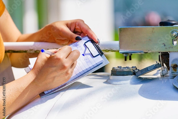 Obraz Woman checking level of propane gas in tank