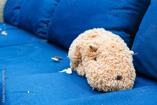 Fototapeta 青いソファに横たわるぬいぐるみ