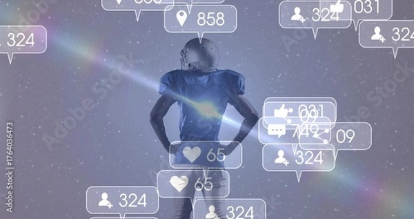 Fototapeta Standing football player wearing helmet and pads facing digital space, with floating media icons