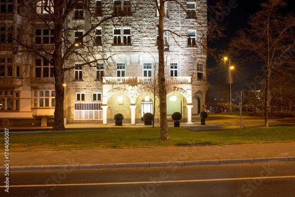 Fototapeta Elegant Nighttime Urban Building Facade