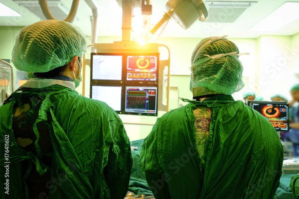 Fototapeta surgeon doctor with coronary monitor.