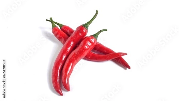 Fototapeta Red hot chili peppers isolated on white background with copy space. Clipping path. Perfect for design element, spicy food concept or any commercial usages. 