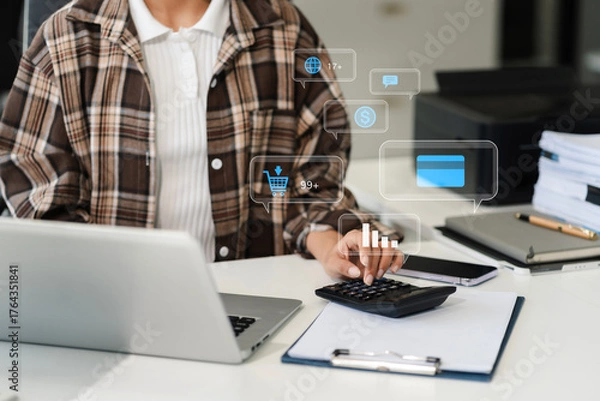 Fototapeta Businesswoman are calculating income-expenditure and analyzing real estate investment data at office, Accounting Financial and tax systems concept.