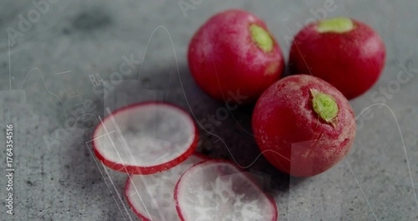 Fototapeta Arranging three red radishes and two radish slices on kitchen countertop, fresh produce