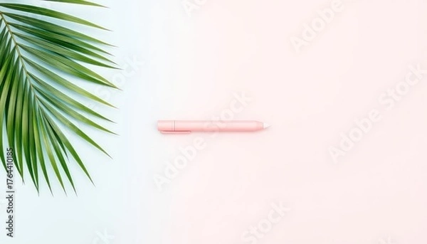 Fototapeta Green palm leaf and pink stylus pen on pastel pink and blue background creating a simple graphic composition