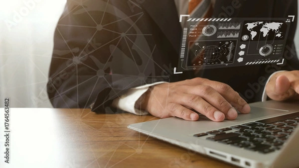 Fototapeta Businessman using laptop with futuristic data interface, global finance and investment analysis concept
