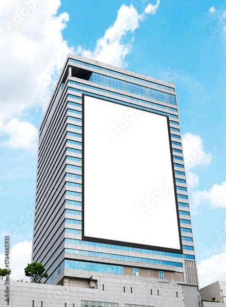Fototapeta Mock up white vertical large LED display billboard on tower building. Clipping path for mockup