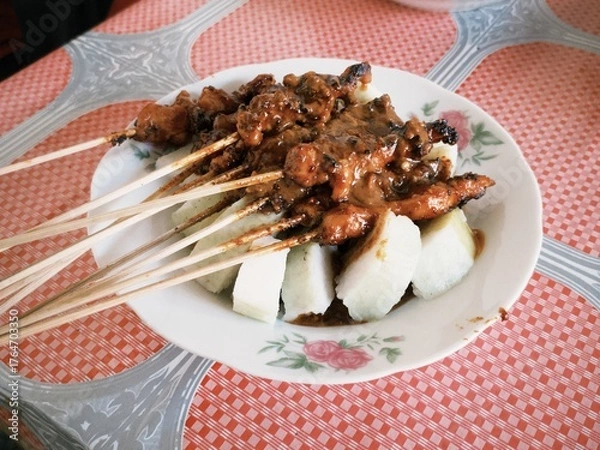 Obraz Sate Kelinci or rabbit satay served with lontong rice cake