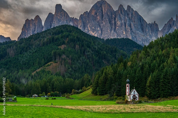 Fototapeta Beautiful mist-covered autumn landscapes in the Dolomites, Italy.- trees, mist, fog, and churches
