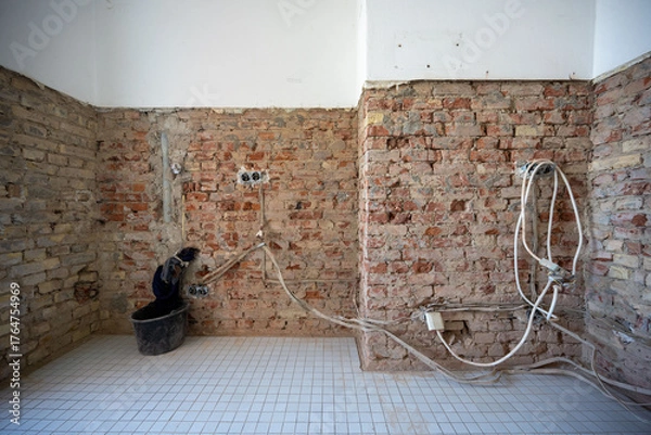 Fototapeta Open interior space with exposed red brick, combining raw materials and industrial charm