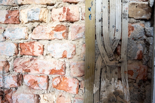 Fototapeta Open interior space with exposed red brick, combining raw materials and industrial charm