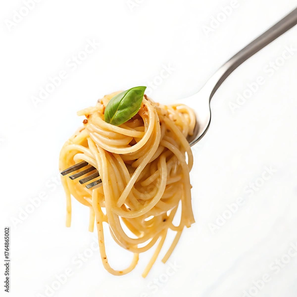 Fototapeta Spaghetti twirled on a fork with a basil leaf on top against a plain white studio background shot