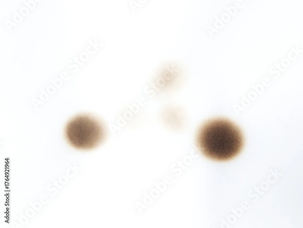 Fototapeta Black burn marks on aged paper with vintage stain details. Paper burned with black marks. Old fire damaged paper with textured burn effects.