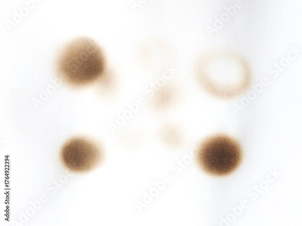 Fototapeta Burned paper with black scorch stains and aged texture. Paper burned with black marks. Old stained paper showing fire damage and discoloration.