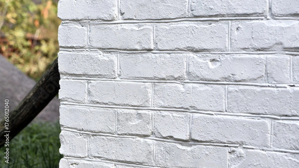 Fototapeta background, brick wall painted white. brick wall facade texture. old bricks in an exterior uneven wall of a house. masonry, construction, repair, restoration. space for text